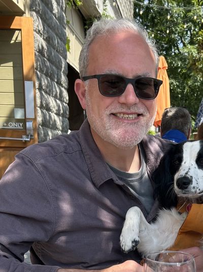 David Ruzumna holding his dog
